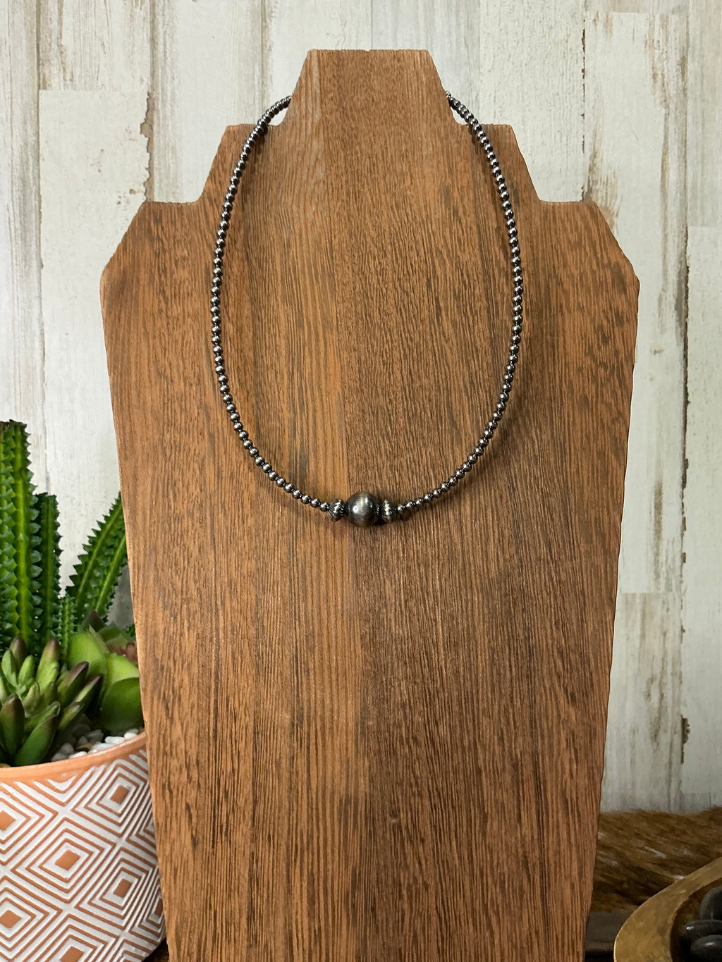 14-inch Sterling Silver Navajo-Style Pearl Necklace with 3 mm beads and a 10 mm center bead.